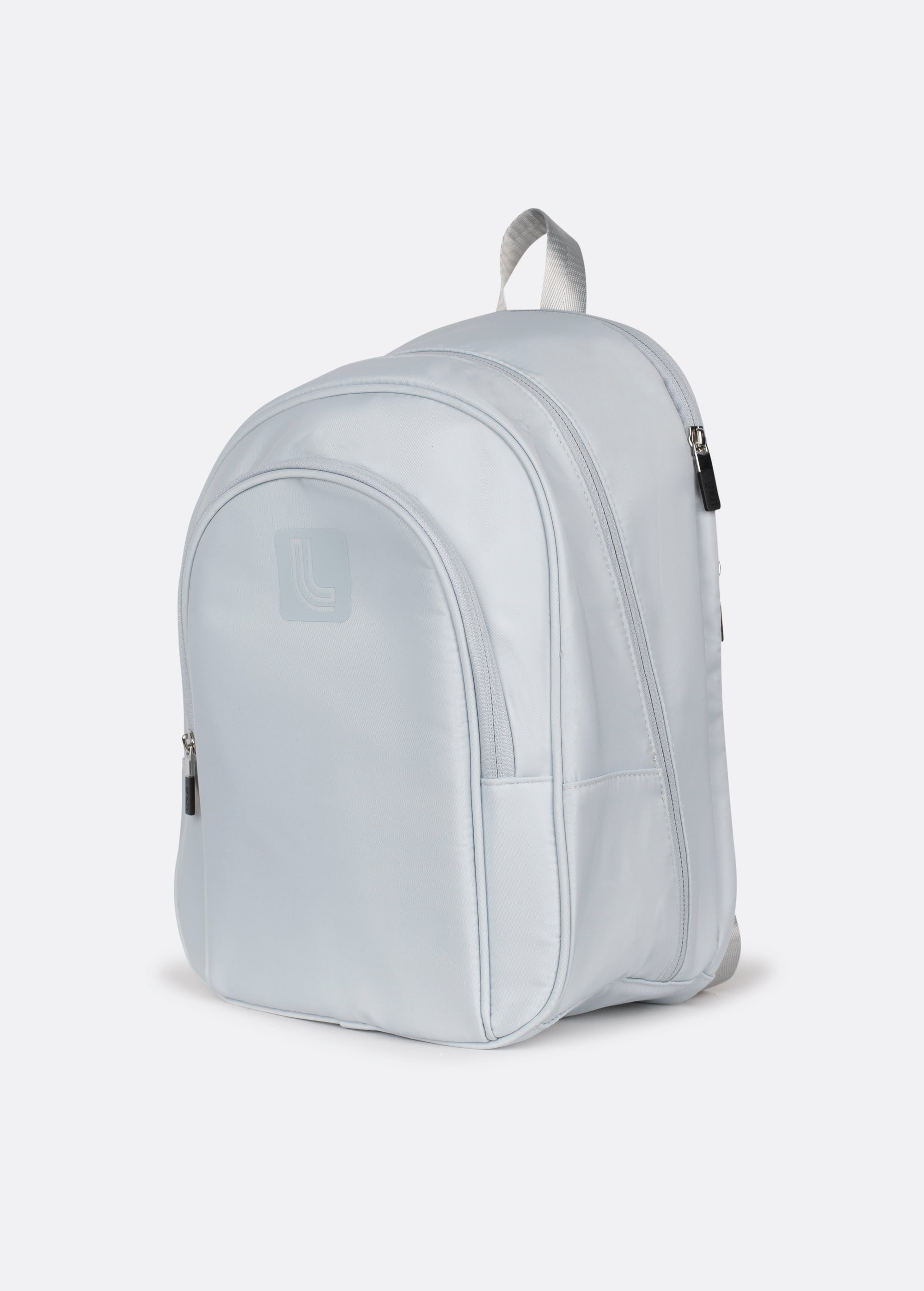 Lolë Chelsea backpack in pale grey, angled front product shot highlighting the rounded shape and side pocket