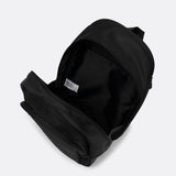 Lolë Chelsea backpack in black, unzipped and viewed from above to reveal the interior lining and front pocket