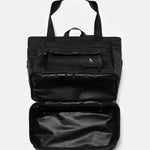 Lolë Lily 2.0 bag in black, with the zip-open bottom compartment expanded to reveal the extra storage space