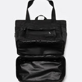 Lolë Lily 2.0 bag in black, with the zip-open bottom compartment expanded to reveal the extra storage space