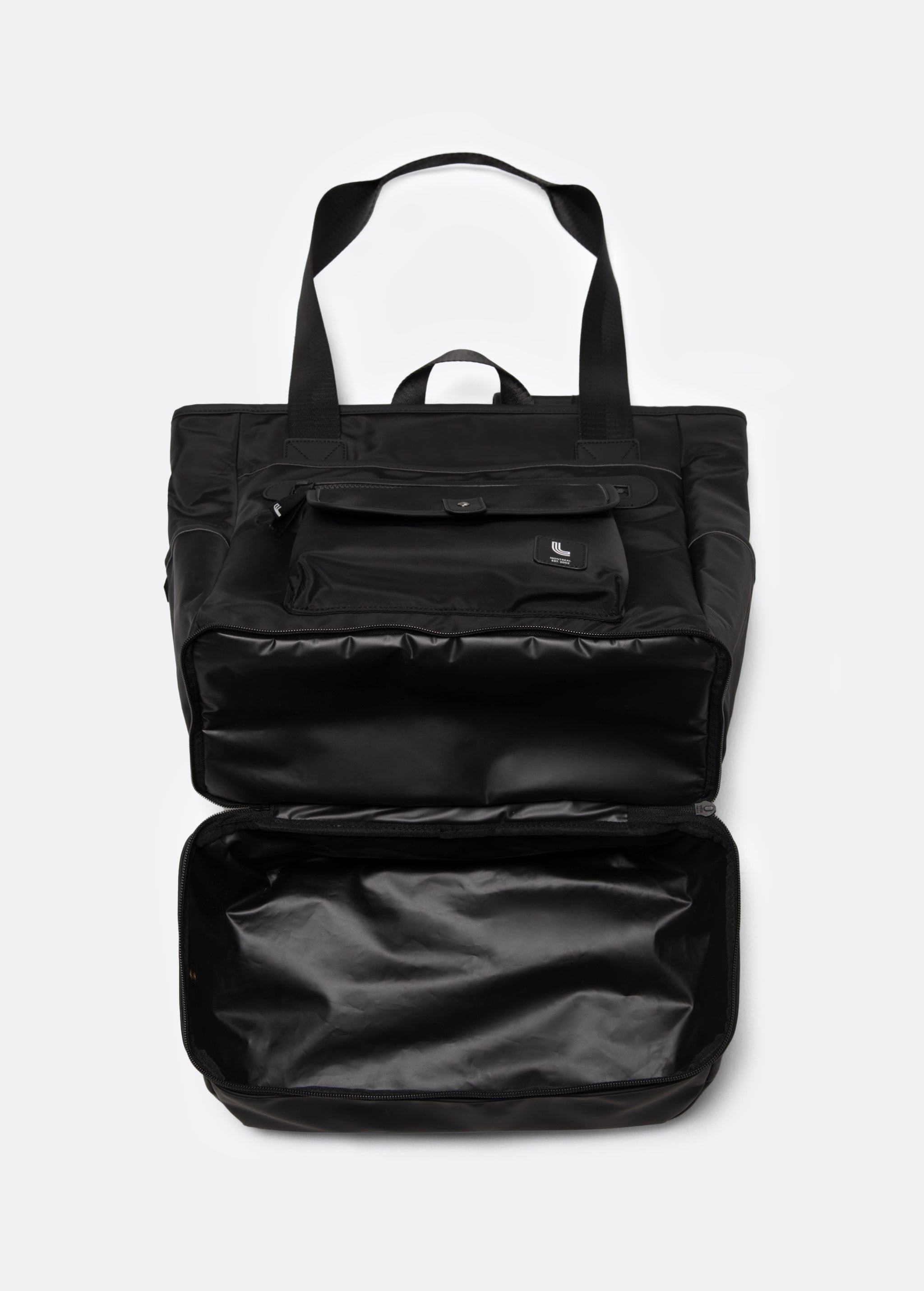 Lolë Lily 2.0 bag in black, with the zip-open bottom compartment expanded to reveal the extra storage space