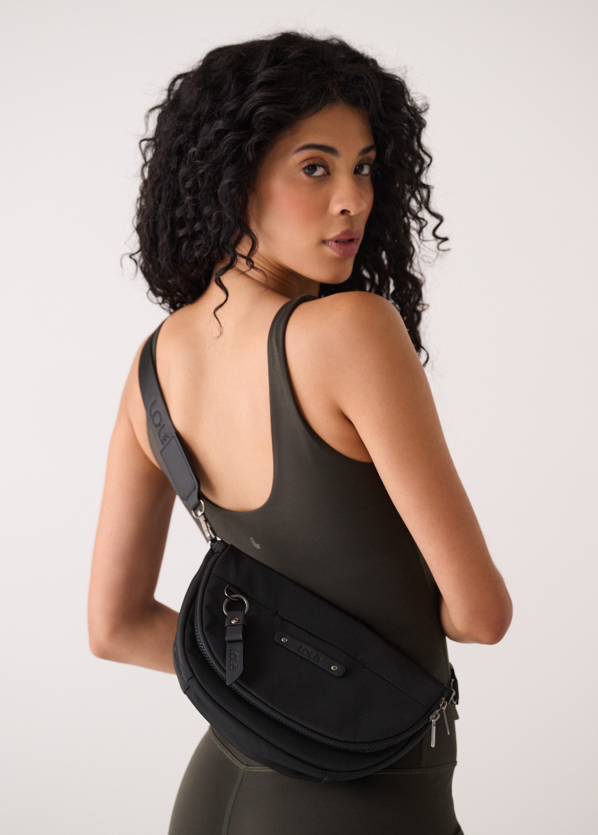 Lolë Acadie Flap Bag in black — the Acadie Flap Bag balances clean design with everyday function