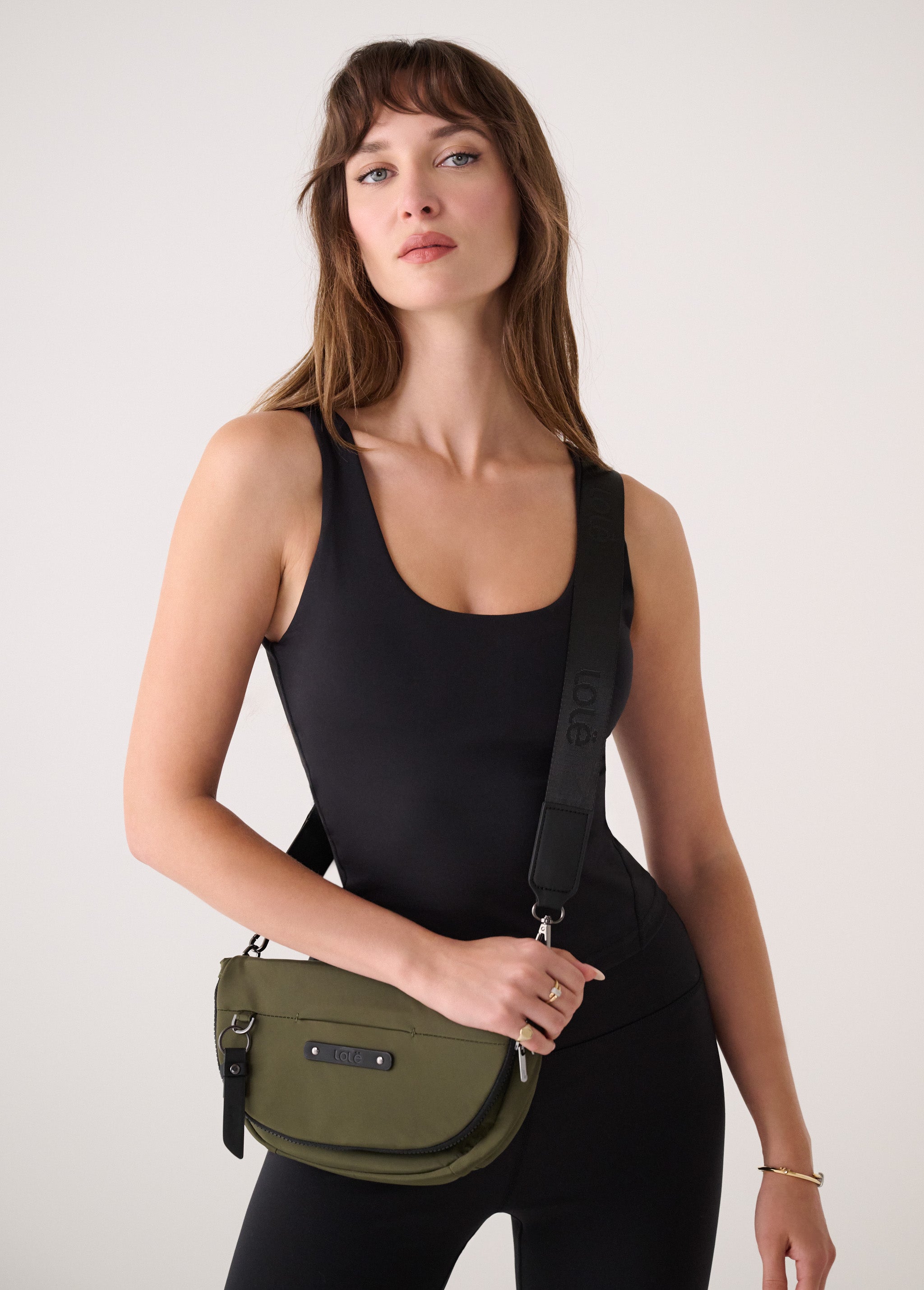 Lolë Acadie Flap Bag in Moss olive green — the Acadie Flap Bag balances clean design with everyday function