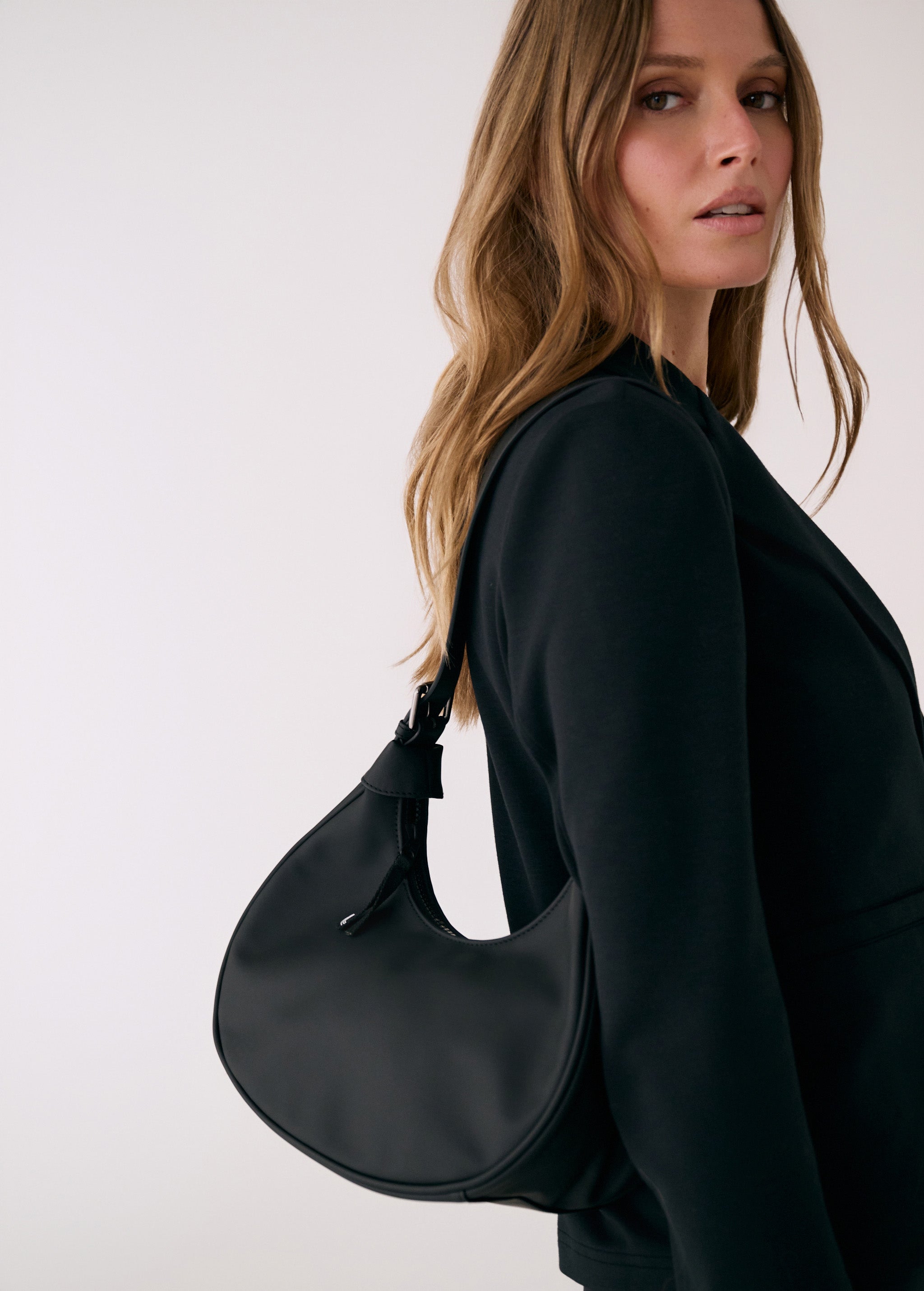 Lolë Mini Hobo Bag in black — consider this sleek bag elevated, inside and out