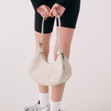 Lolë Mini Hobo Bag in Birch cream — consider this sleek bag elevated, inside and out