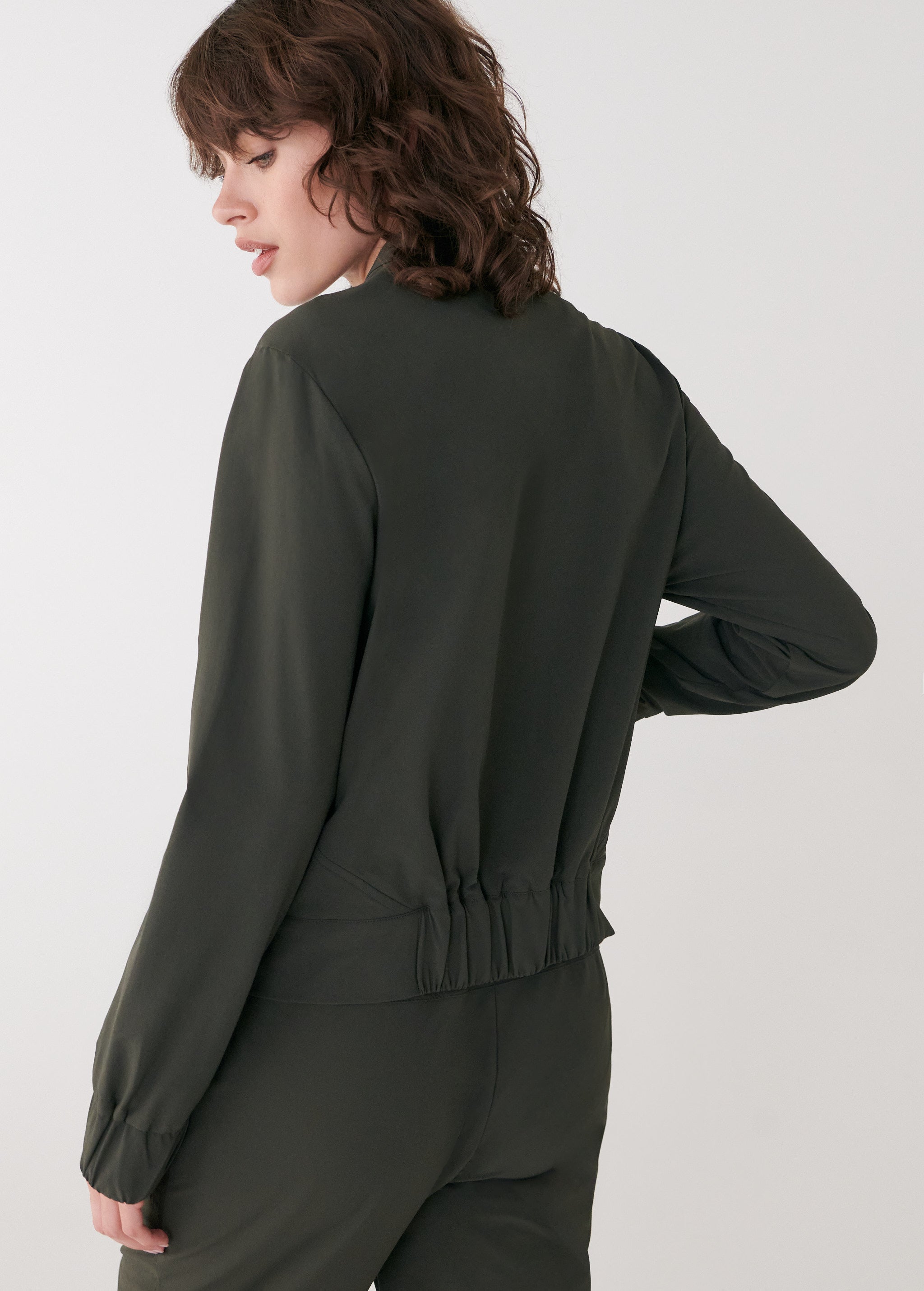 Lolë Momentum Tech Bomber in olive — pair it with the matching pant for an easy total look