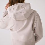 Lolë Yonder Full Zip Hoodie in Abalone pale greige — cropped and cozy, the Yonder Hoodie is your cold-weather comfort zone