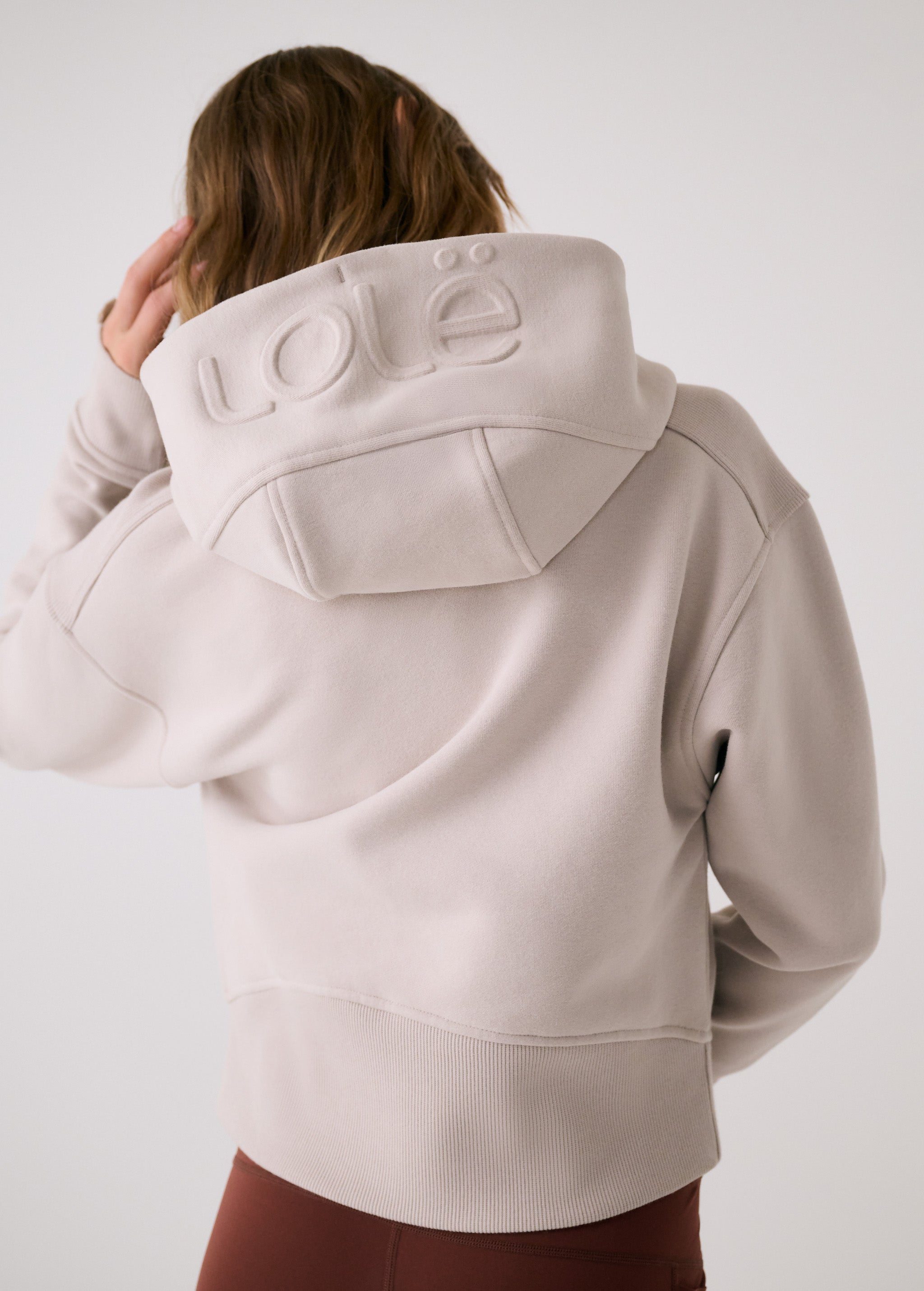 Lolë Yonder Full Zip Hoodie in Abalone pale greige — cropped and cozy, the Yonder Hoodie is your cold-weather comfort zone