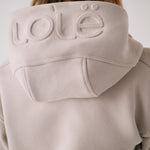 Lolë Yonder Full Zip Hoodie in Abalone pale greige — cropped and cozy, the Yonder Hoodie is your cold-weather comfort zone