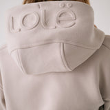 Lolë Yonder Full Zip Hoodie in Abalone pale greige — cropped and cozy, the Yonder Hoodie is your cold-weather comfort zone
