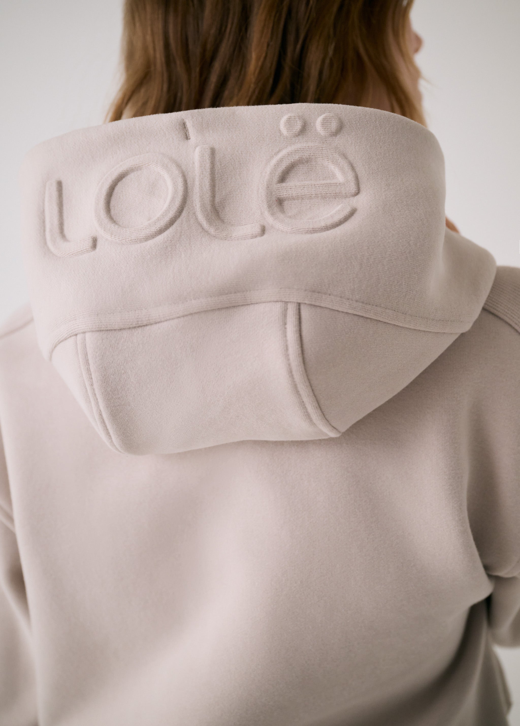 Lolë Yonder Full Zip Hoodie in Abalone pale greige — cropped and cozy, the Yonder Hoodie is your cold-weather comfort zone