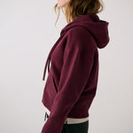 Lolë Yonder Full Zip Hoodie in burgundy — cropped and cozy, the Yonder Hoodie is your cold-weather comfort zone