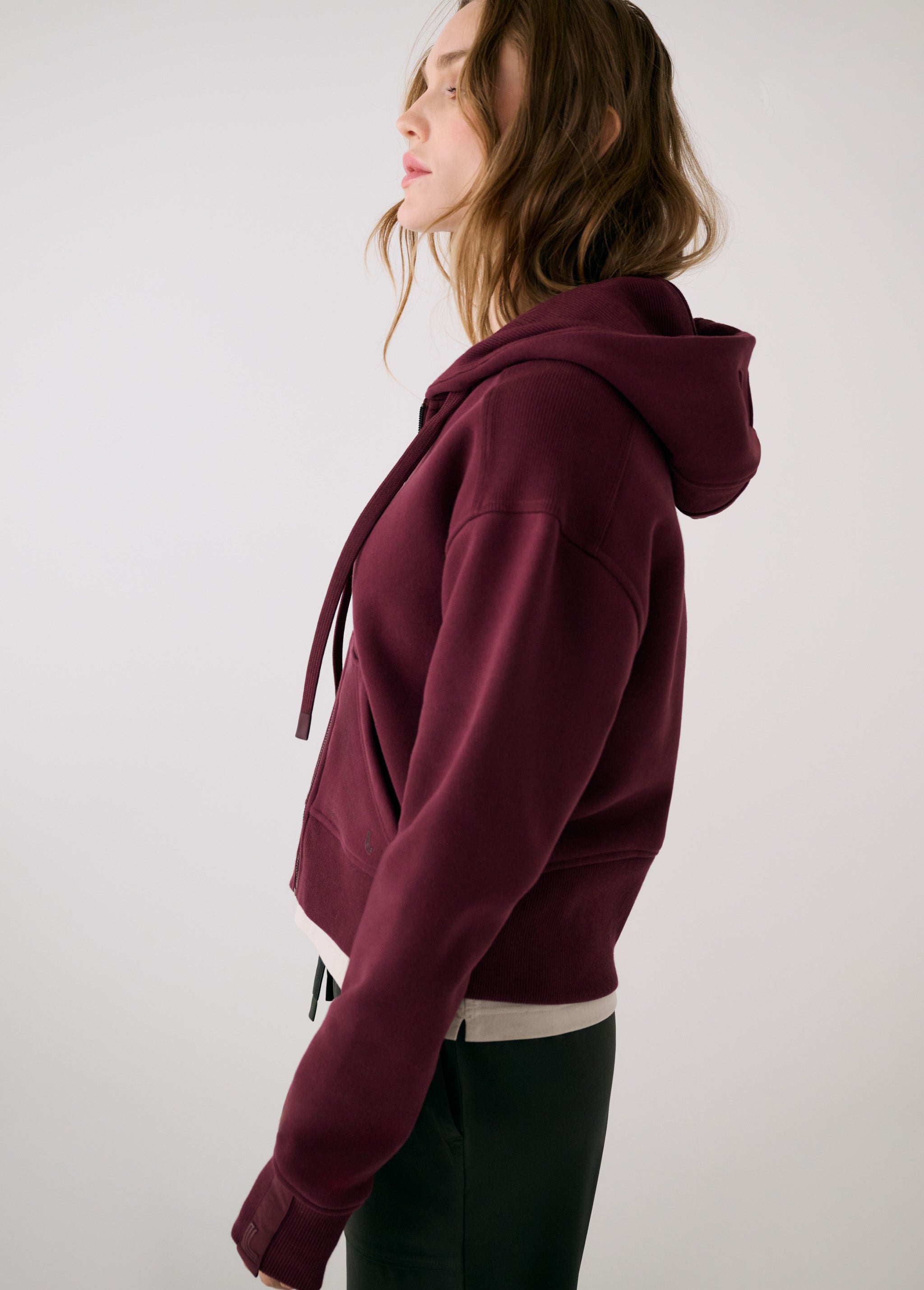 Lolë Yonder Full Zip Hoodie in burgundy — cropped and cozy, the Yonder Hoodie is your cold-weather comfort zone