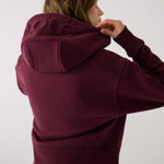 Lolë Yonder Full Zip Hoodie in burgundy — cropped and cozy, the Yonder Hoodie is your cold-weather comfort zone