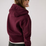 Lolë Yonder Full Zip Hoodie in burgundy — cropped and cozy, the Yonder Hoodie is your cold-weather comfort zone