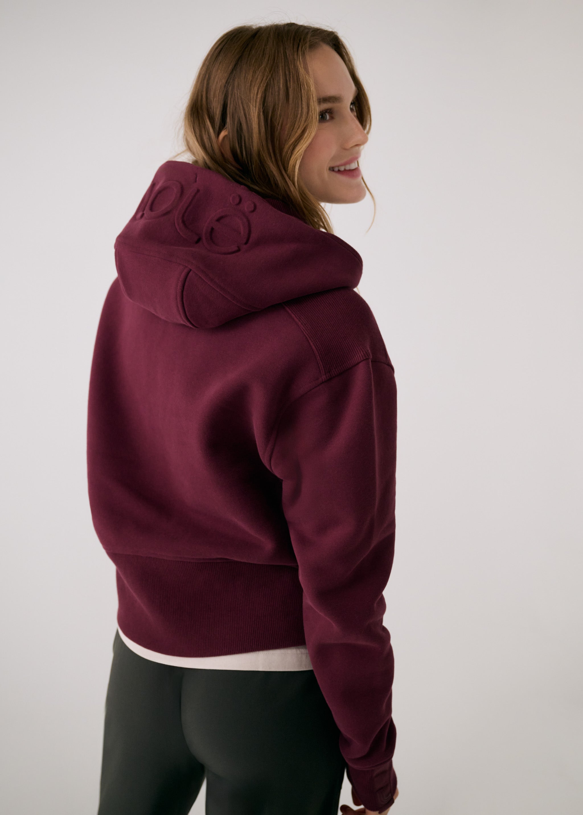Lolë Yonder Full Zip Hoodie in burgundy — cropped and cozy, the Yonder Hoodie is your cold-weather comfort zone