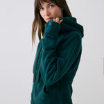 Lolë Yonder Full Zip Hoodie in teal — cropped and cozy, the Yonder Hoodie is your cold-weather comfort zone