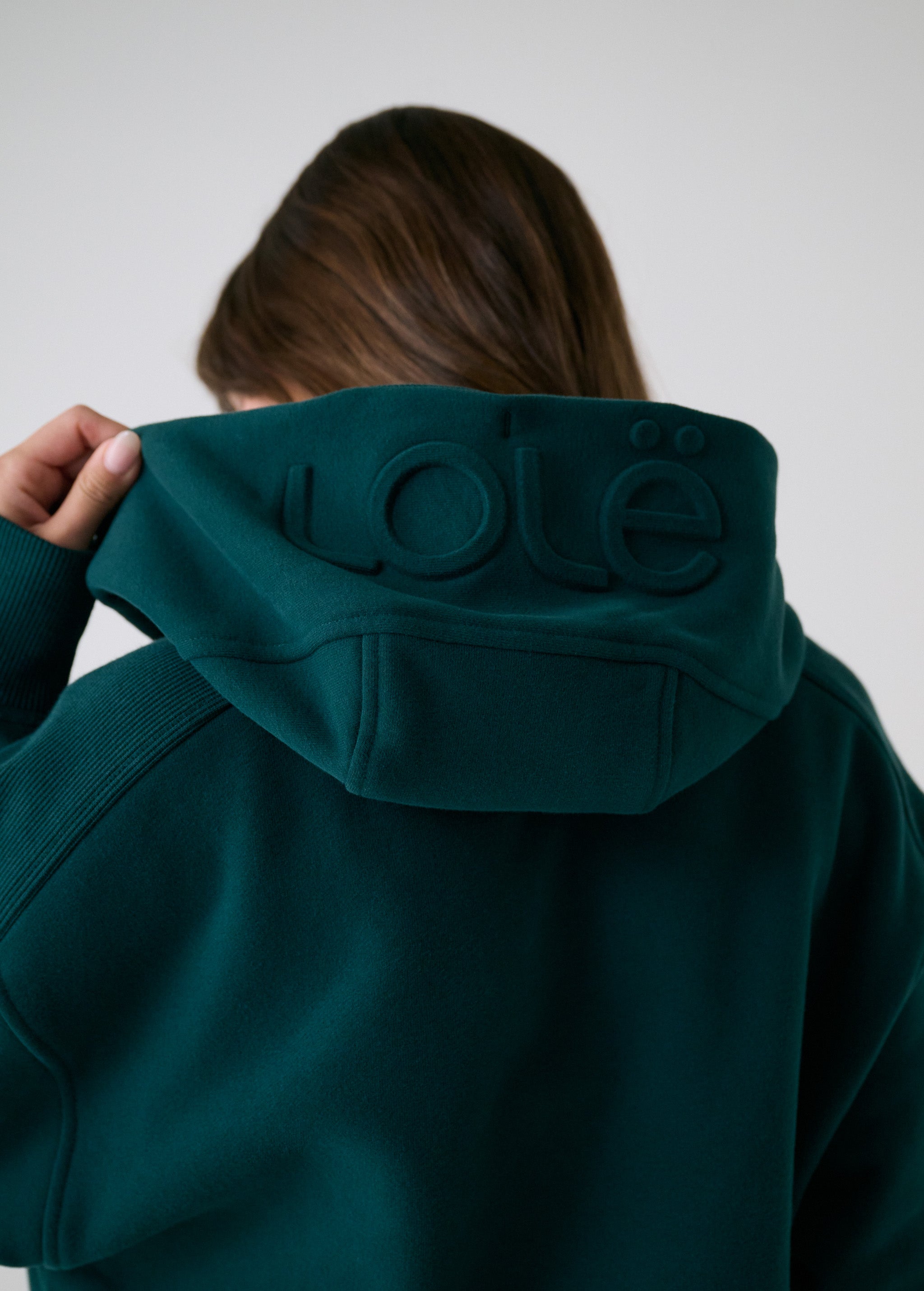 Lolë Yonder Full Zip Hoodie in teal — cropped and cozy, the Yonder Hoodie is your cold-weather comfort zone