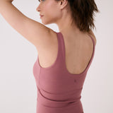 Lolë Serene Support tank top in berry, back view with low scoop neckline and logo