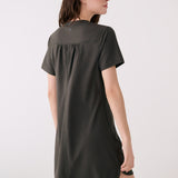 Lolë Olivie V-neck t-shirt dress in olive, back view with gathered yoke and curved shirttail hem