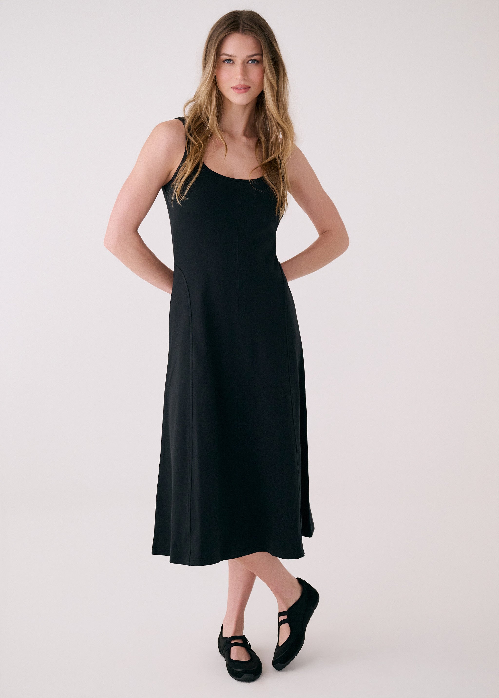 Lolë Core dress in black, front view on model — sleeveless scoop-neck A-line