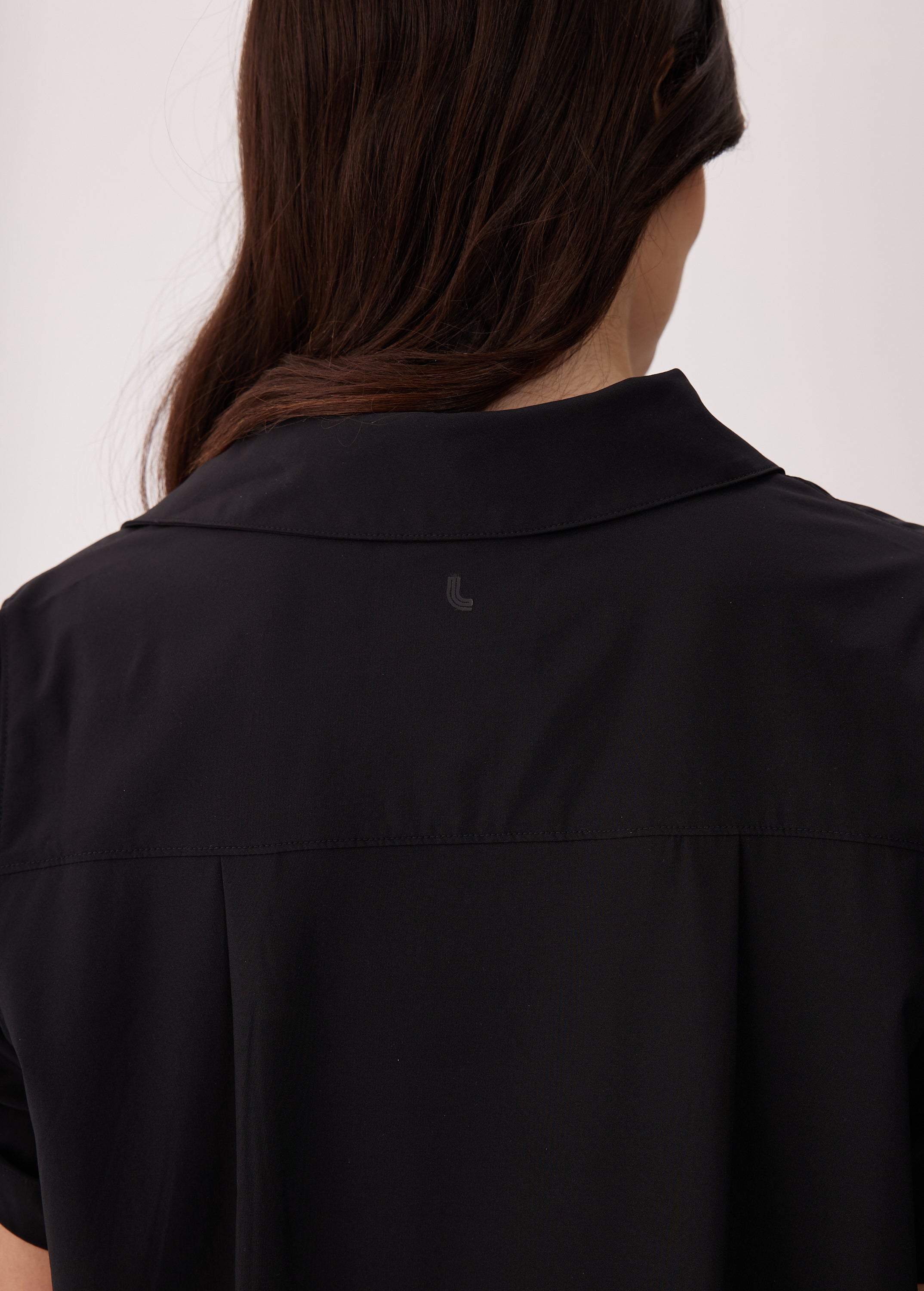 Lolë Momentum Shirt Dress in black — a polished shirt dress with a Lolë twist
