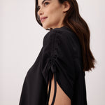 Lolë Momentum Shirt Dress in black — a polished shirt dress with a Lolë twist