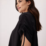 Lolë Momentum Shirt Dress in black — a polished shirt dress with a Lolë twist