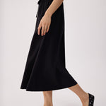 Lolë Momentum Ruched Midi Dress in black — the dress that gets you out the door faster than your morning coffee