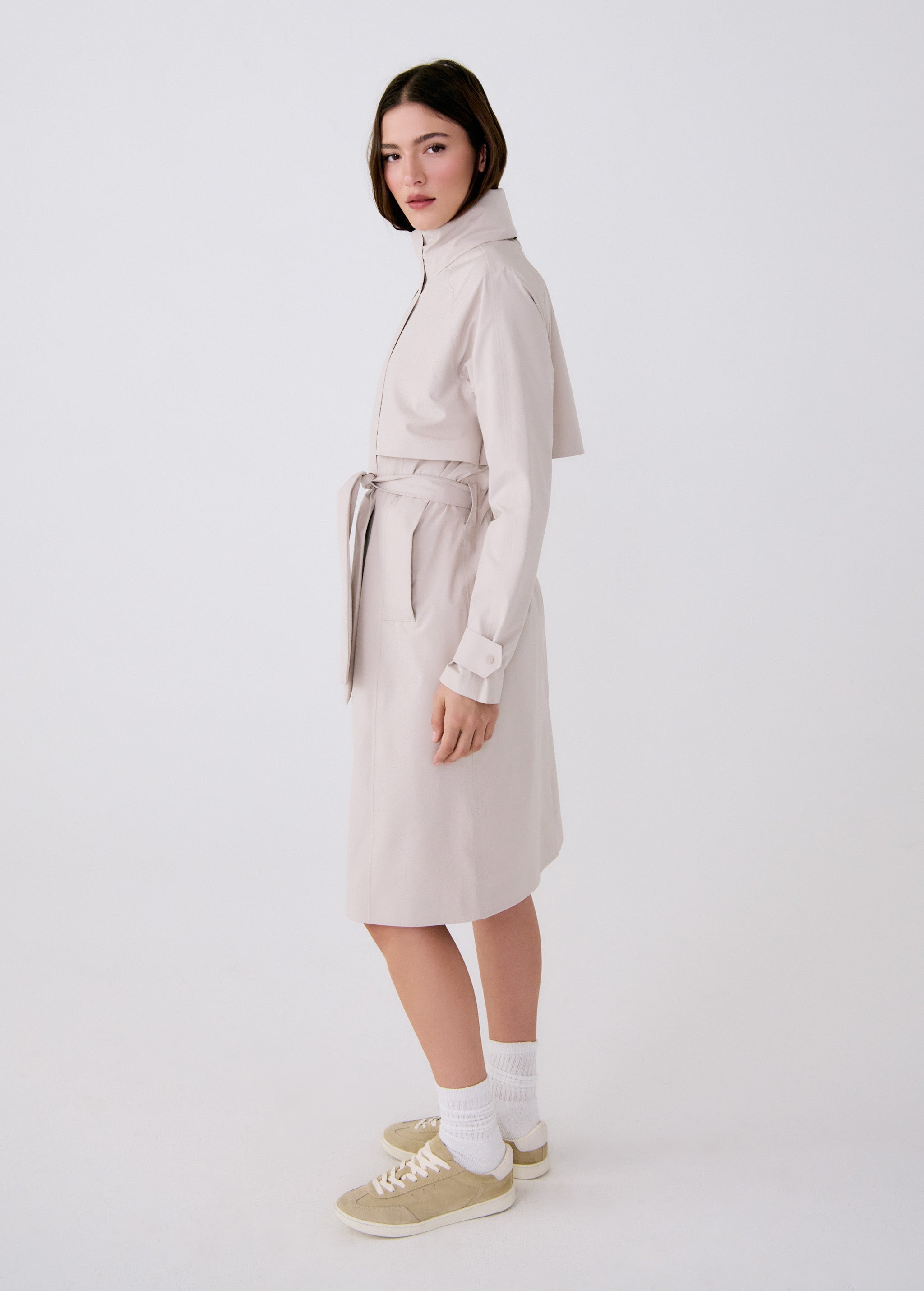 Lolë Alizé rain trench coat in oatmeal, side view of the belted mid-length trench