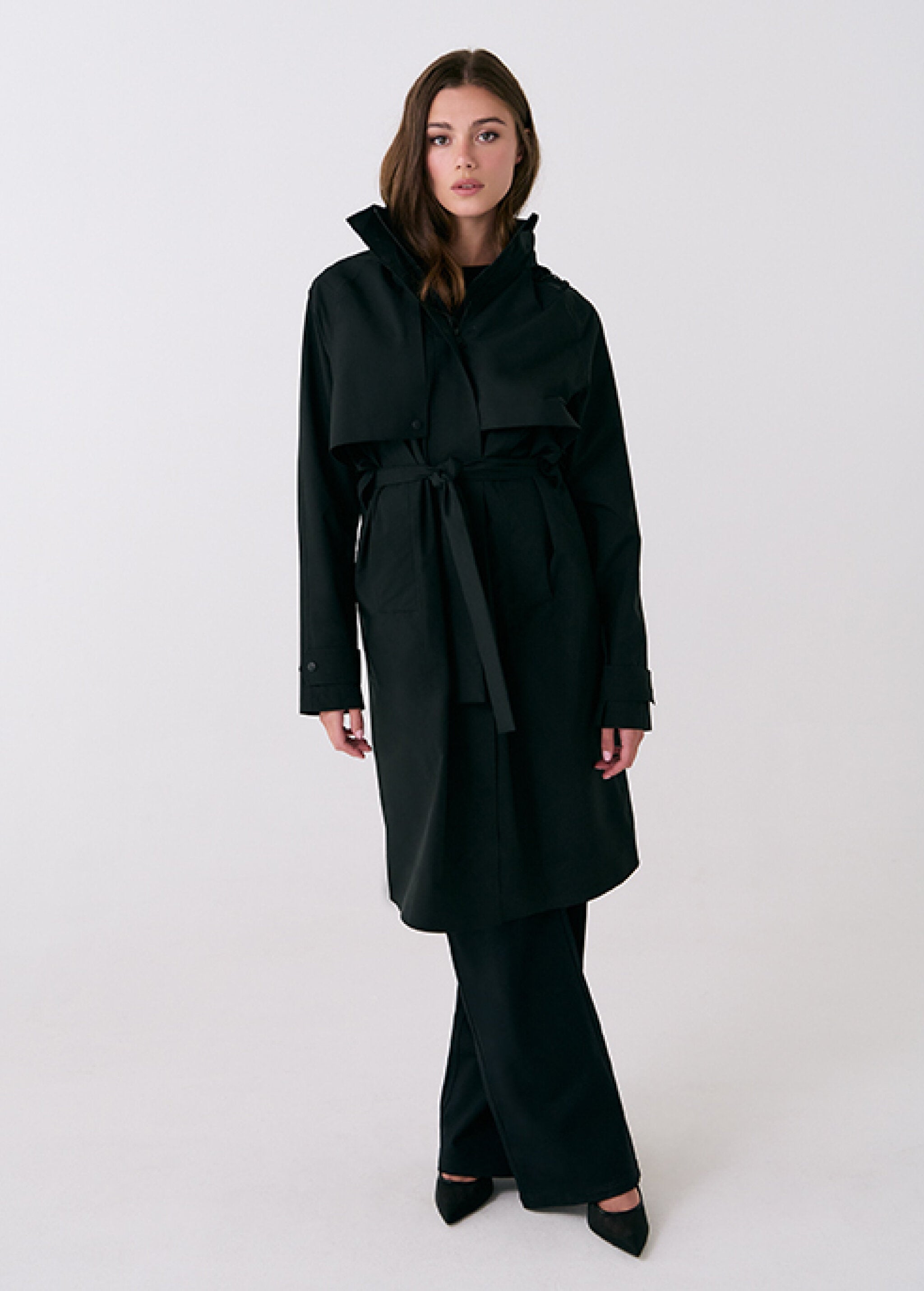 Lolë Alizé rain trench coat in black, full front view on model — belted mid-length trench