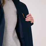 Lolë Piper 2.0 rain jacket in navy, held open to show the interior zip pocket with a yellow pull cord