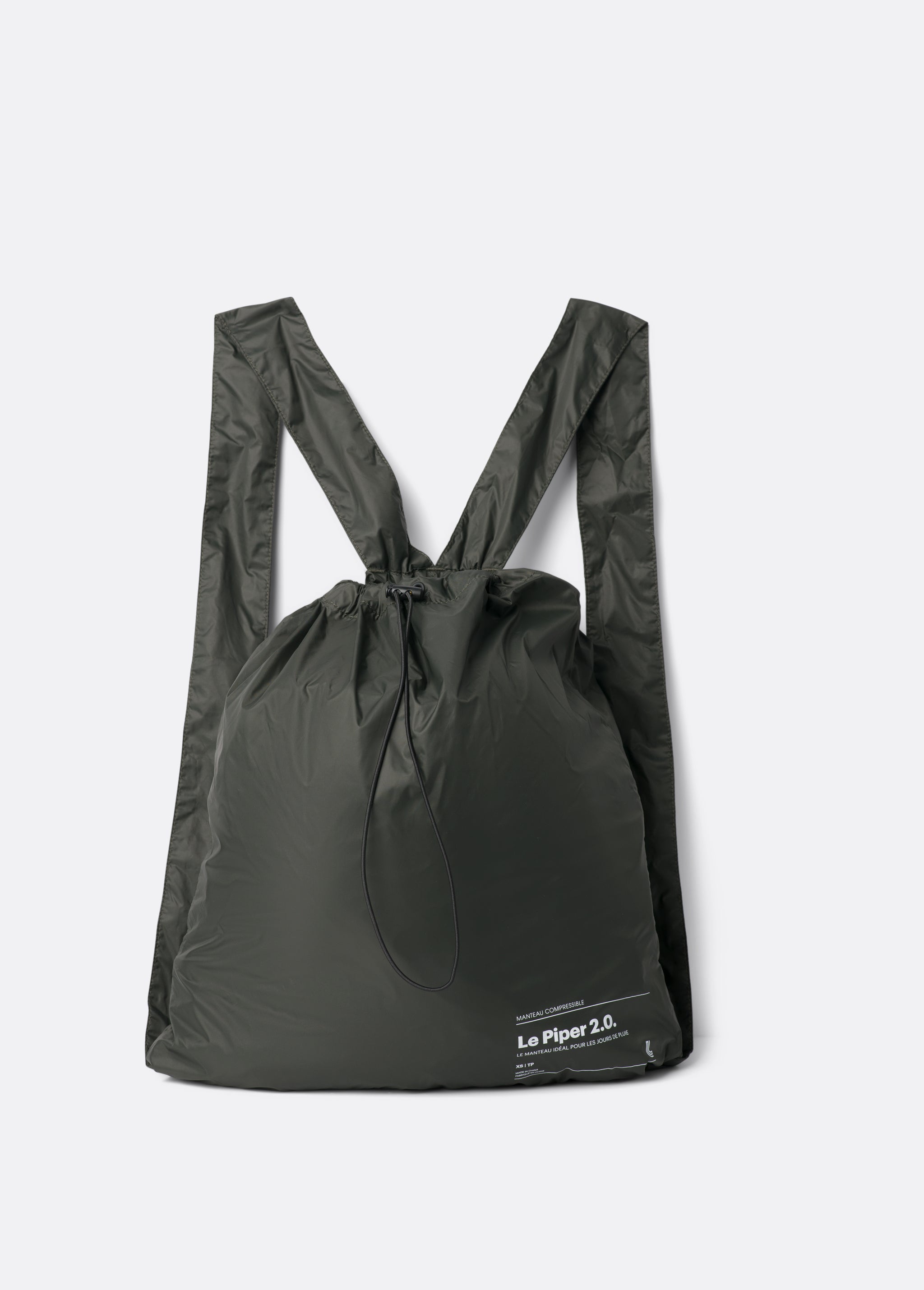 Lolë Piper 2.0 rain jacket in olive green, folded flat into its matching drawstring backpack pouch