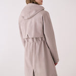 Lolë Piper 2.0 rain jacket in taupe, back view with hood down showing the drawcord waist and centre back vent