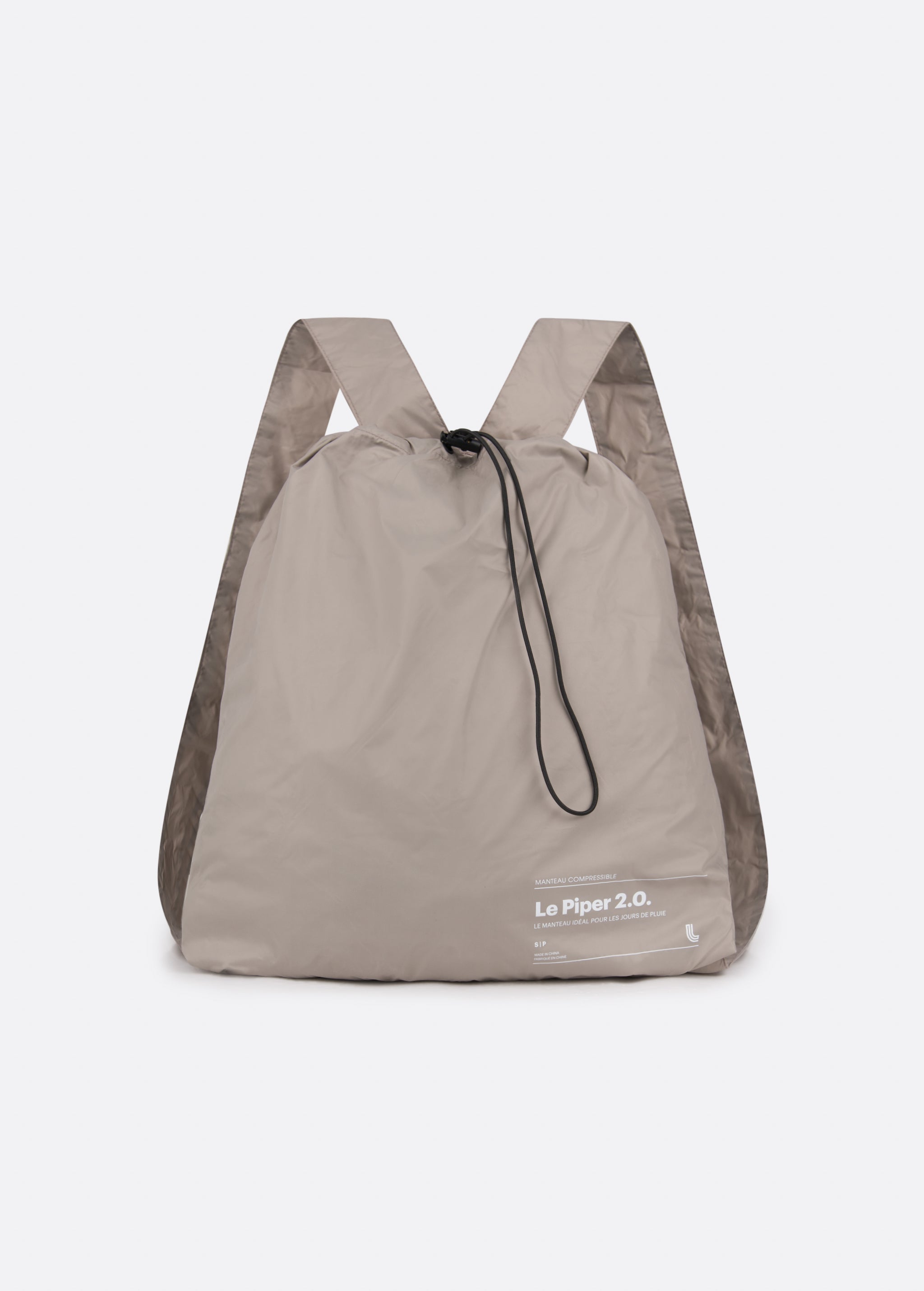 Lolë Piper 2.0 rain jacket in taupe, packed into its matching drawstring backpack pouch, front view