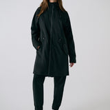 Lolë Piper 2.0 rain jacket in black, full front view zipped up with hood, drawcord waist toggles and hip pockets