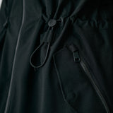 Lolë Piper 2.0 rain jacket in black, close-up of the branded drawcord waist toggle and zip hip pocket