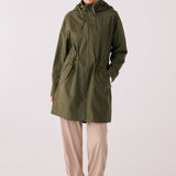 Lolë Piper 2.0 rain jacket in olive green, full front view zipped up with hood and drawcord waist