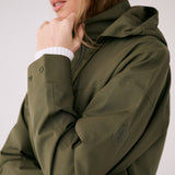 Lolë Piper 2.0 rain jacket in olive green, close-up of the buttoned cuff and circular sleeve logo