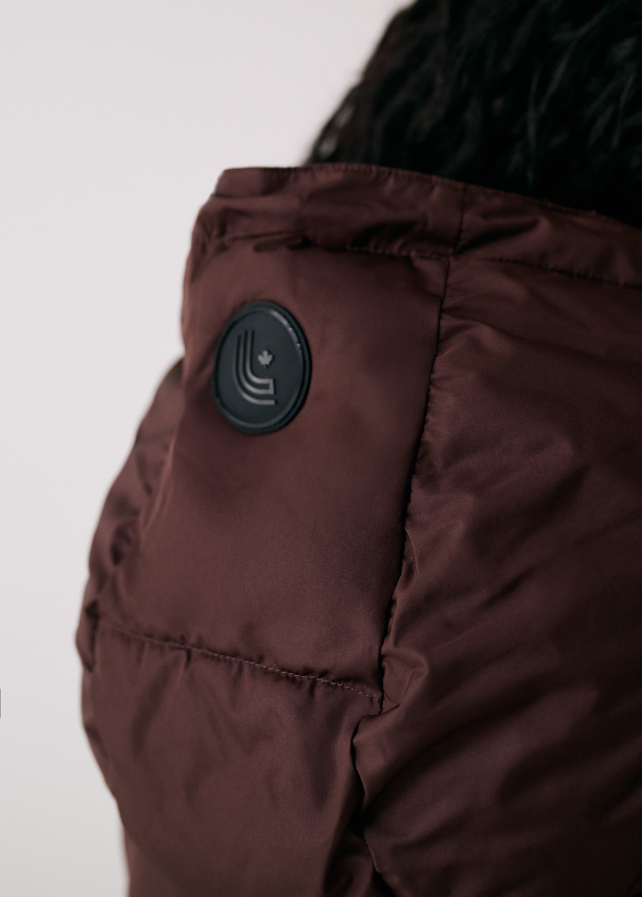 Lolë London Cropped Vest in Java dark brown — wear it over a hoodie or under a coat
