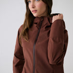 Lolë Element Long Rain Jacket in Sienna brown — this longline jacket keeps water out while keeping your look sharp