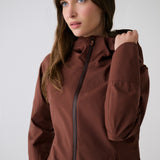 Lolë Element Long Rain Jacket in Sienna brown — this longline jacket keeps water out while keeping your look sharp