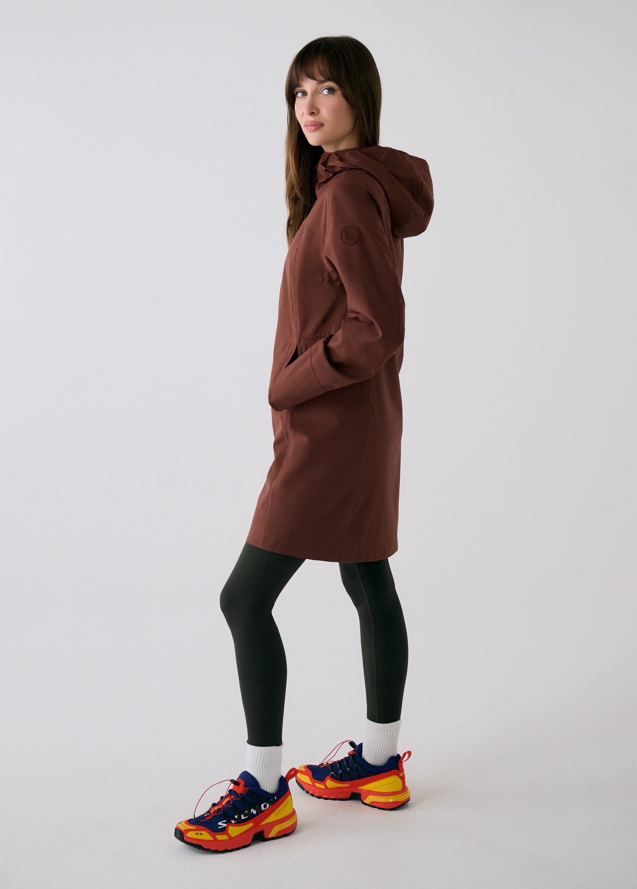 Lolë Element Long Rain Jacket in Sienna brown — this longline jacket keeps water out while keeping your look sharp