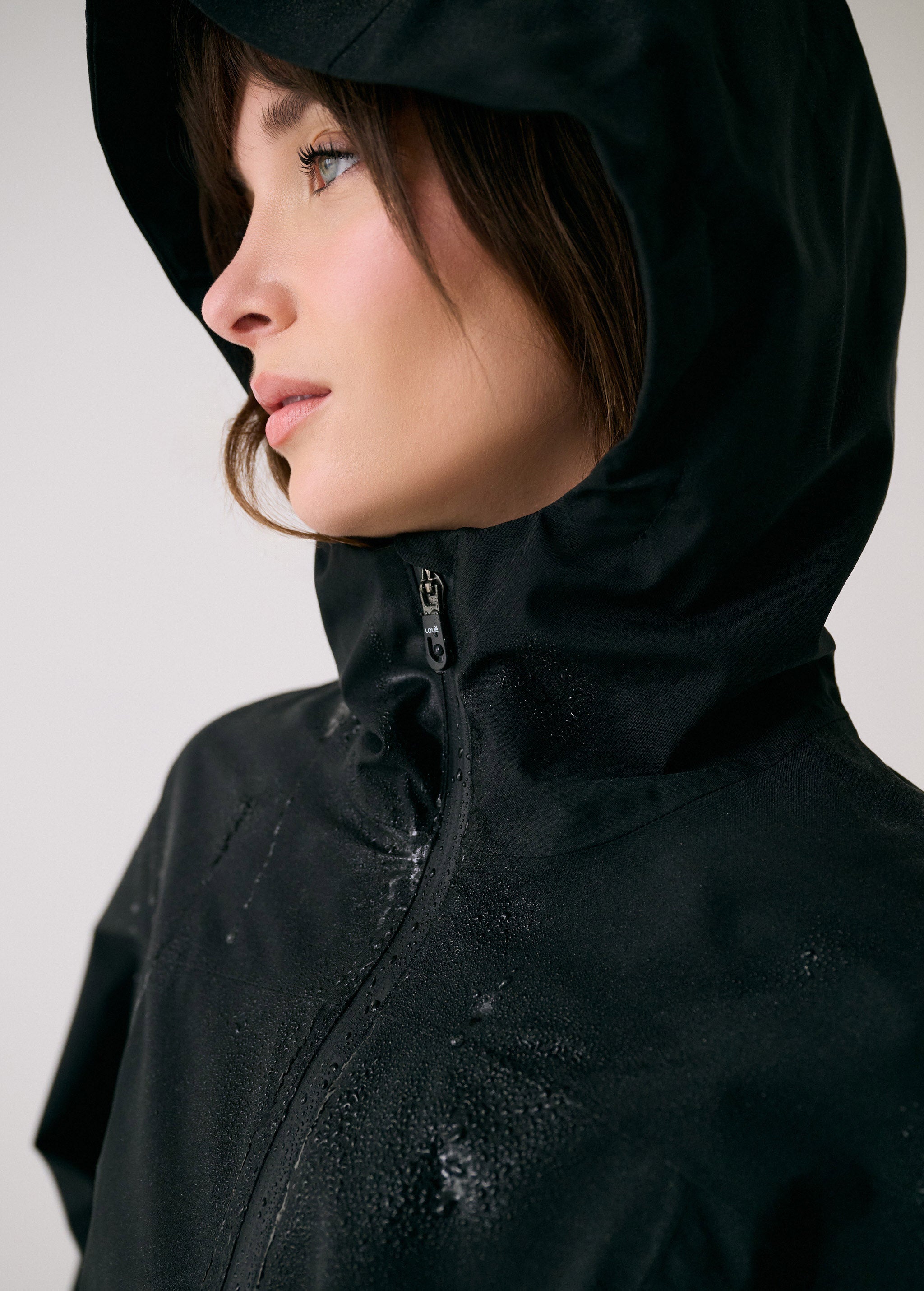 Lolë Element Long Rain Jacket in black — this longline jacket keeps water out while keeping your look sharp