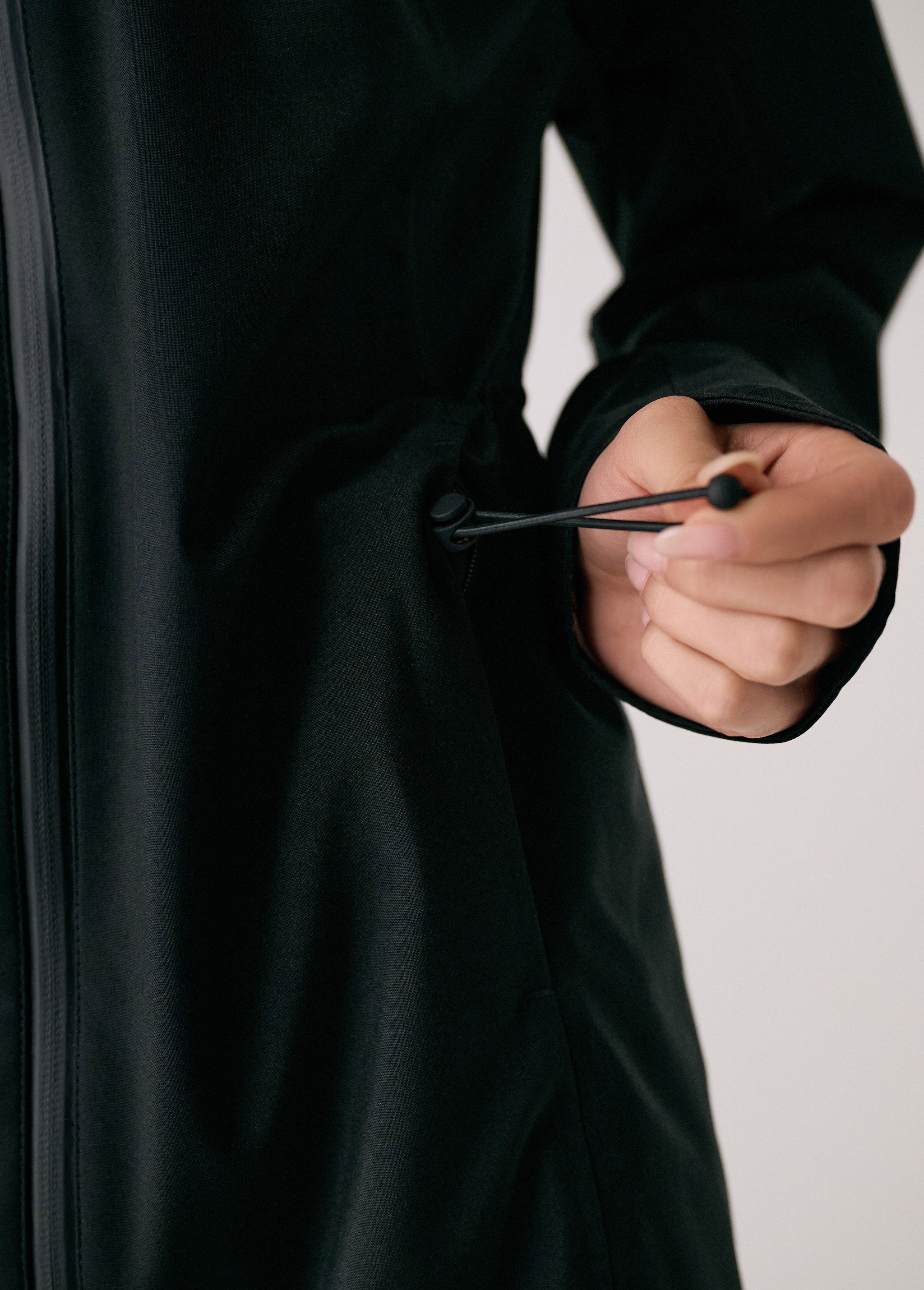 Lolë Element Long Rain Jacket in black — this longline jacket keeps water out while keeping your look sharp