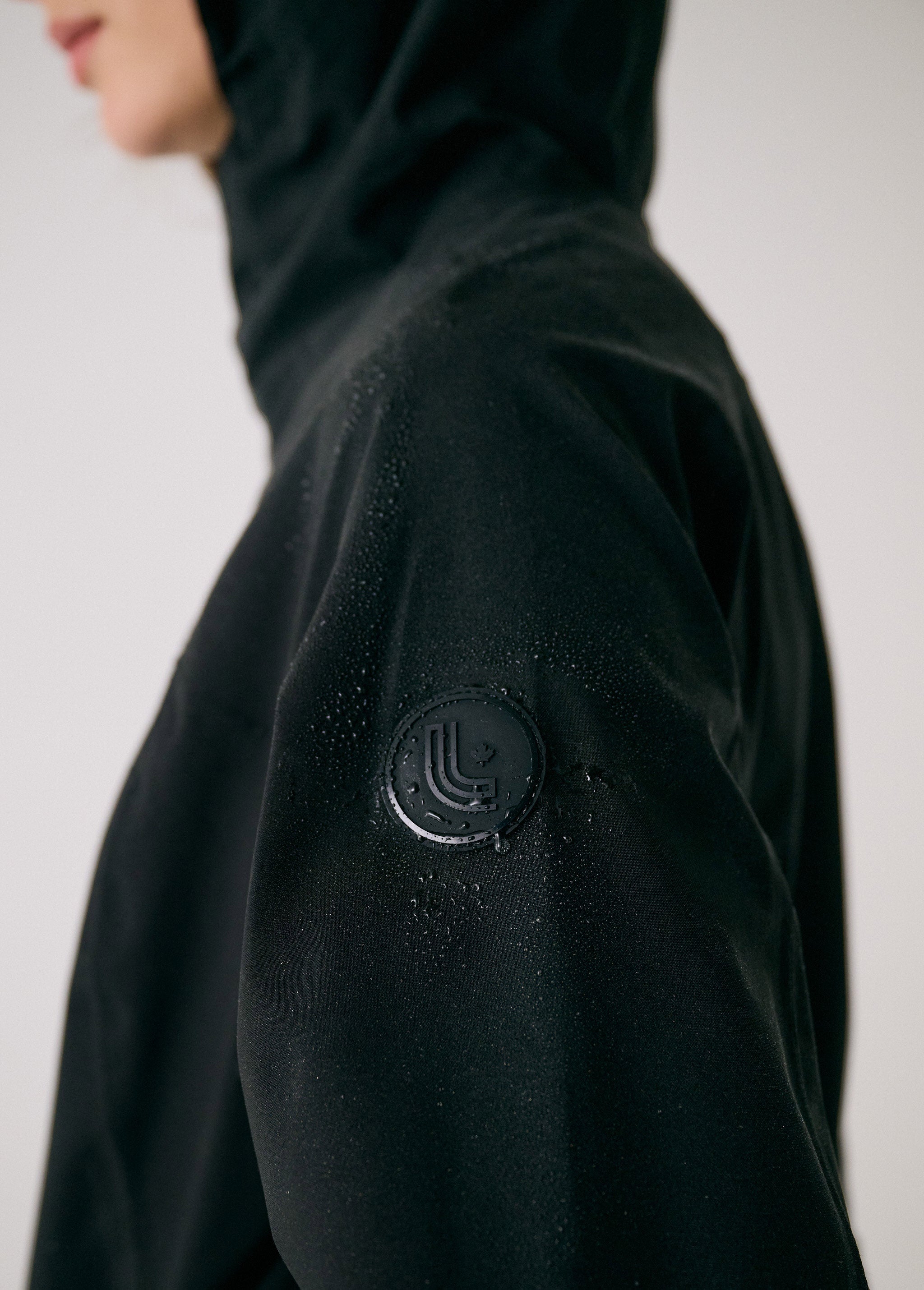 Lolë Element Long Rain Jacket in black — this longline jacket keeps water out while keeping your look sharp