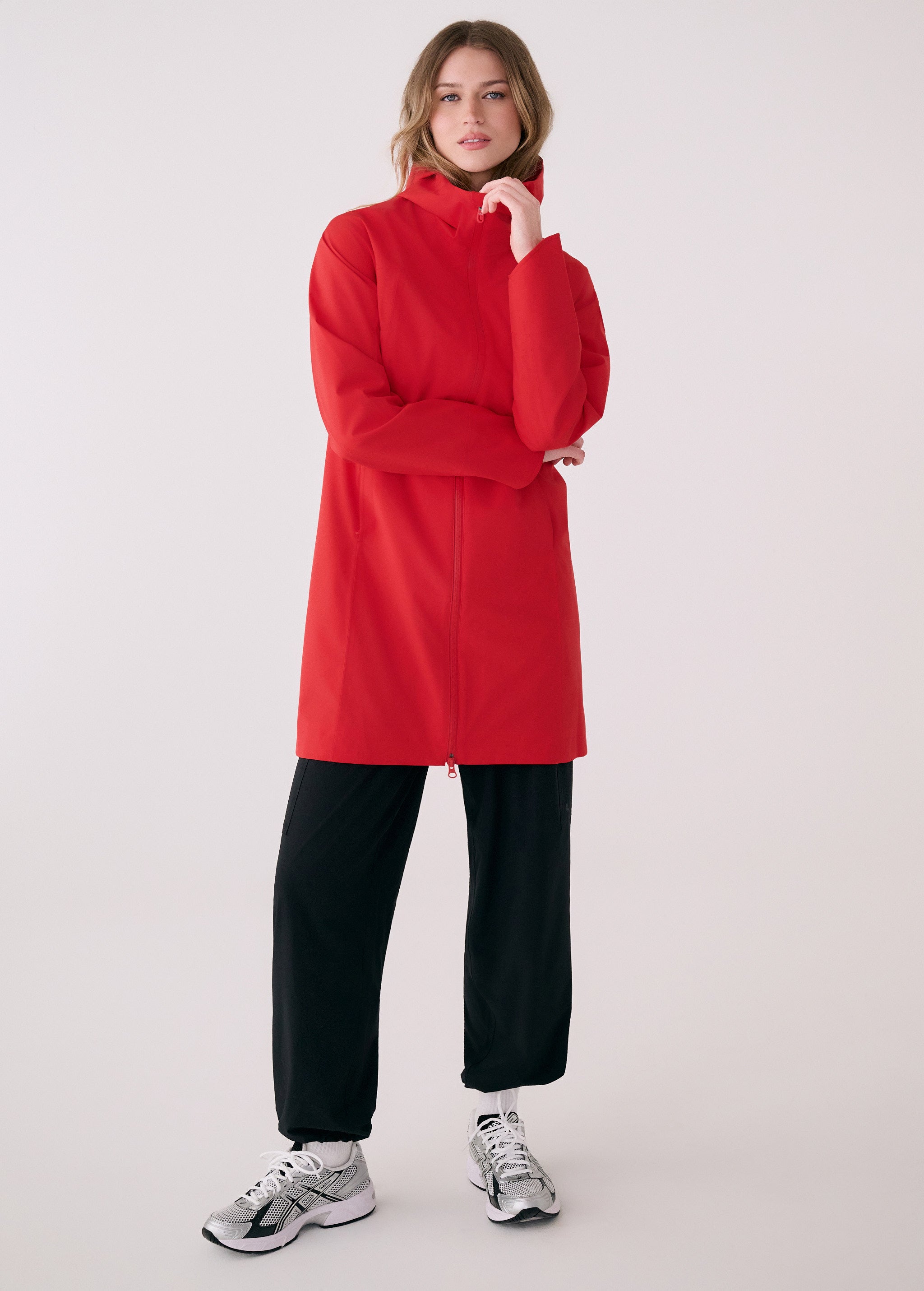 Lolë Element Long Rain Jacket in Poppy red — this longline jacket keeps water out while keeping your look sharp