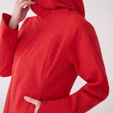 Lolë Element Long Rain Jacket in Poppy red — this longline jacket keeps water out while keeping your look sharp