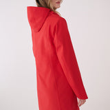 Lolë Element Long Rain Jacket in Poppy red — this longline jacket keeps water out while keeping your look sharp