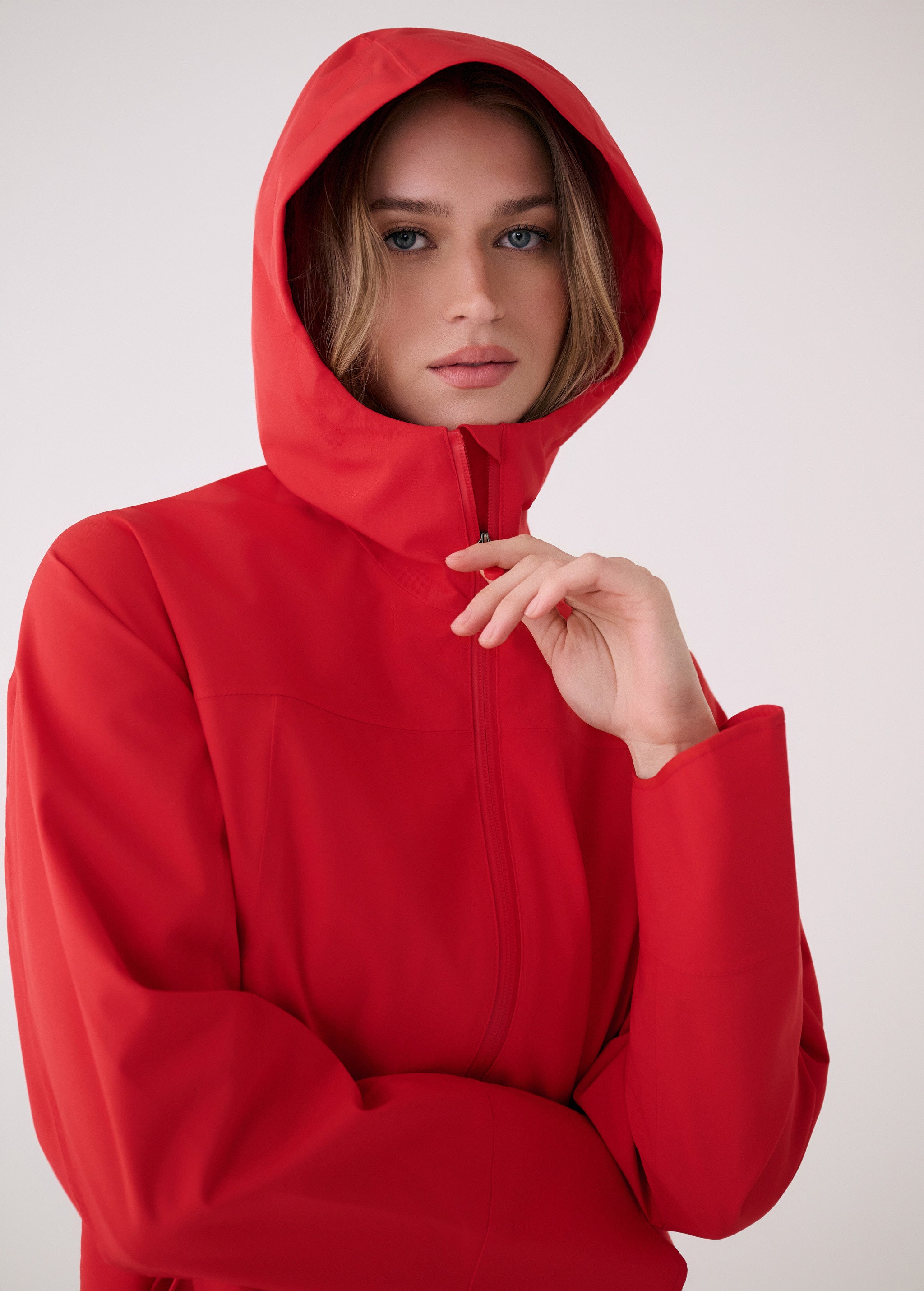 Lolë Element Long Rain Jacket in Poppy red — this longline jacket keeps water out while keeping your look sharp